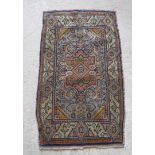 A Turkish rug with centre medallion on a pale blue ground,
