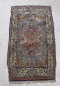 A Turkish rug with centre medallion on a pale blue ground,