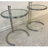 A pair of Eileen Grey "E1027" circular chrome framed glass top adjustable occasional tables, 50.
