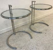 A pair of Eileen Grey "E1027" circular chrome framed glass top adjustable occasional tables, 50.