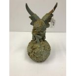 A modern cast iron figure of a fairy seated on a flower ball, approx 32 cm high,