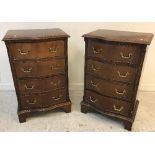 A pair of modern reproduction mahogany serpentine fronted bedside chests of four drawers on bracket