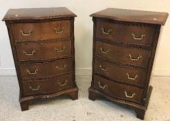 A pair of modern reproduction mahogany serpentine fronted bedside chests of four drawers on bracket