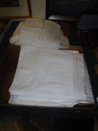 Two boxes of assorted bed and table linens to include napkins, various sheets,