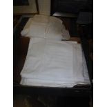 Two boxes of assorted bed and table linens to include napkins, various sheets,