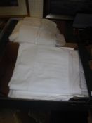 Two boxes of assorted bed and table linens to include napkins, various sheets,