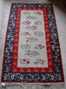 A Kelim rug with cream ground central field decorated with floral sprays,