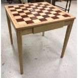 A modern French beech and stained beech chess table,