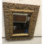 A modern gilt framed rectangular wall mirror with scrolling acanthus decoration in the Rococo taste,
