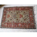 A Tabriz rug with scrolling floral and foliate decoration on a cream ground,