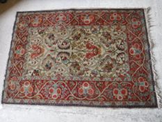 A Tabriz rug with scrolling floral and foliate decoration on a cream ground,