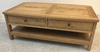 A John Lewis oak coffee table with two frieze drawers on rectangular supports united by an