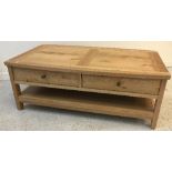 A John Lewis oak coffee table with two frieze drawers on rectangular supports united by an