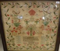 A Victorian needlework sampler decorated with Adam and Eve, flowers in vase, Cupids, stags,