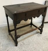 A 19th Century oak side table, the plank top with moulded edge over a single frieze drawer,