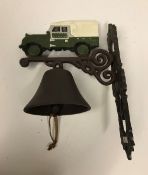 A modern painted cast metal wall bell with Landrover decoration