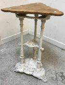 A Victorian cast iron table base of three foliate decorated column form on a tri-form base with