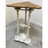 A Victorian cast iron table base of three foliate decorated column form on a tri-form base with