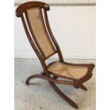 A Victorian stained beech and caned folding campaign chair, 95 cm high,
