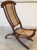 A Victorian stained beech and caned folding campaign chair, 95 cm high,