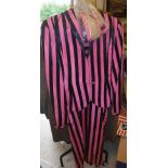 A collection of clothing to include a 1940's/50's pink and black striped trusseau and a black coat,