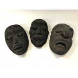Three carved and painted wooden Balinese grotesque masks, the largest 21.5 cm x 14.