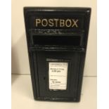 A modern black post box,