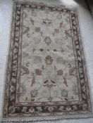 A Ziegler design carpet, the central panel set with foliate design on a cream ground,