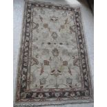 A Ziegler design carpet, the central panel set with foliate design on a cream ground,