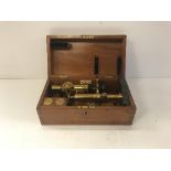 A circa 1900 mahogany cased lacquered brass and anodised monocular microscope,