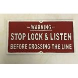 A modern painted cast metal sign "Warning Stop Look and Listen Before Crossing the Line",