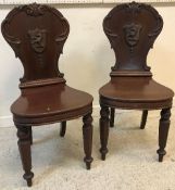 A pair of early 19th Century mahogany panel seated hall chairs,