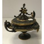 A 19th Century French bronze and gilt bronze urn of squat form decorated with grape and vine, 19.
