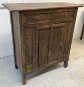 A late George III oak hanging corner cupboard with shell marquetry inlaid medallion and fielded