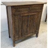 A late George III oak hanging corner cupboard with shell marquetry inlaid medallion and fielded