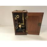 A circa 1900 mahogany cased lacquered brass and black painted monocular microscope, un-named,