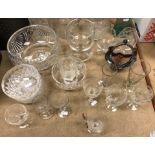 A collection of glassware to include a pair of hobnail cut decanters,