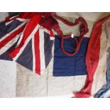A vintage Union flag together with a navy and cream pennant flag and a length of tricolor material,