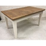 A modern oak rectangular extending dining table with spare leaf,
