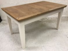 A modern oak rectangular extending dining table with spare leaf,