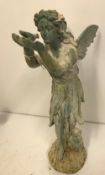 A cast iron figure of a fairy with shell in her hand and another with bird in her hand,