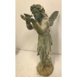 A cast iron figure of a fairy with shell in her hand and another with bird in her hand,