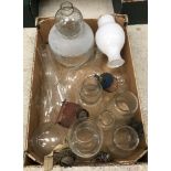 A box containing various oil lamp shades and a box containing an oil lamp and various glass and