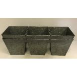 A pair of three joined square tapering planters,