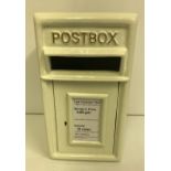 A modern white post box,