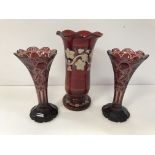 A pair of cranberry glass trumpet shaped vases,