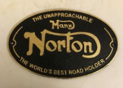 A modern painted cast iron sign inscribed "Norton",