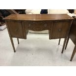 An Edwardian mahogany and inlaid serpentine fronted sideboard with central drawer flanked by two