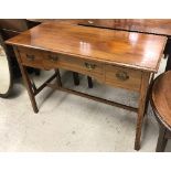 An Edwardian mahogany three drawer side table on square tapered legs united by stretchers,
