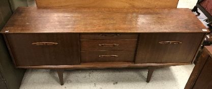 A 1970's Jentique teak sideboard, the plain top over three central drawers,